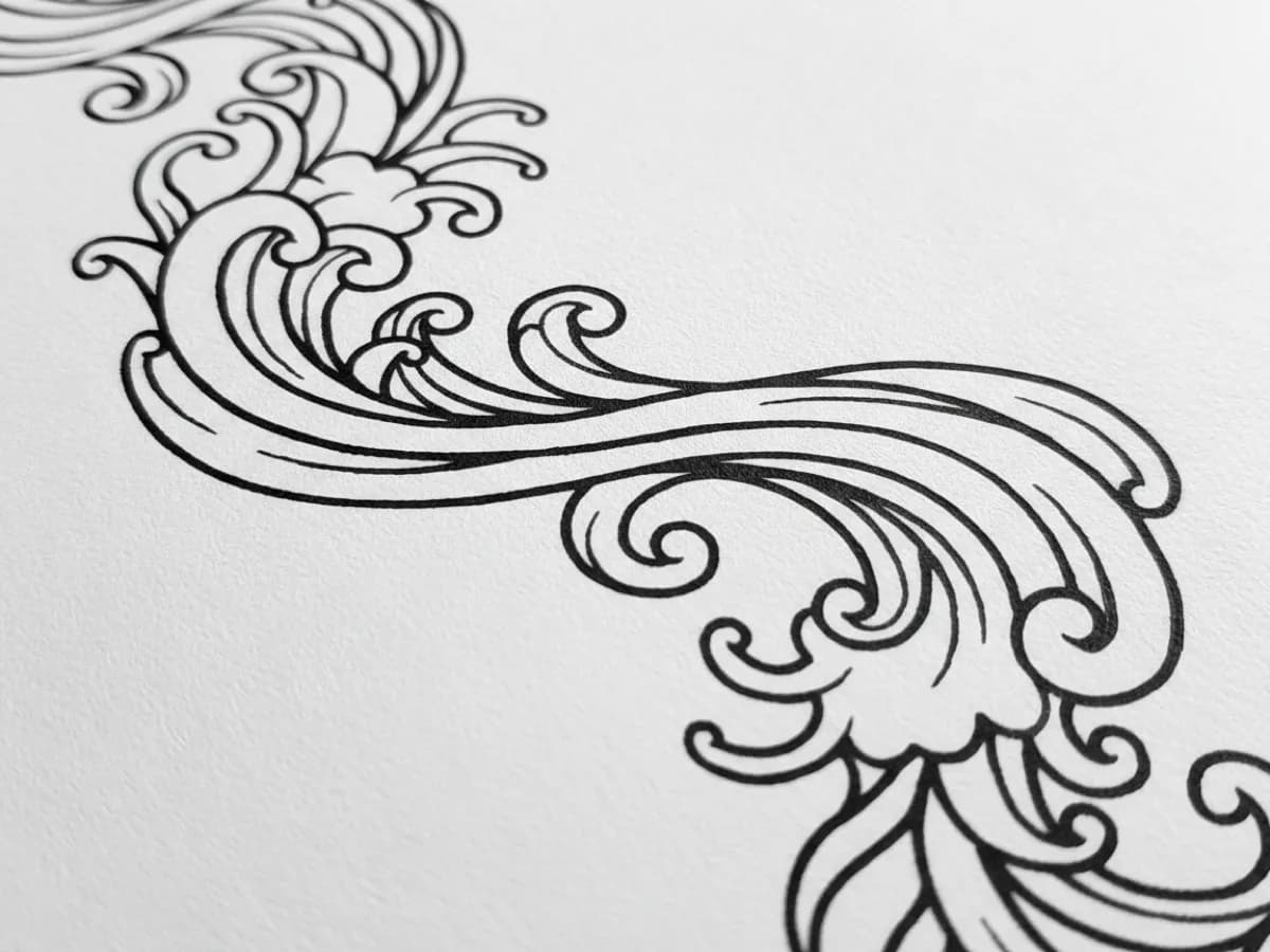 Black tattoo stencil linework on paper at high magnification, showing smooth unbroken curves with clean edges